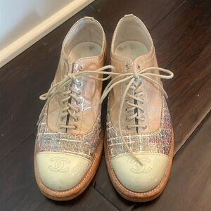 Chanel lace up shoe in neutral colors with CC logo in toe cap